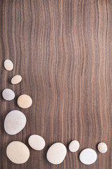 light pebbles on wooden ebony tree background