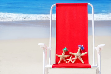 Beach chair with starfishes by the ocean