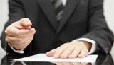 Businessman offering a pen to sign a contract