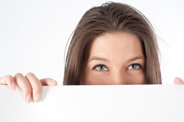 woman hiding behind billboard