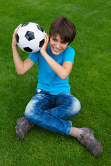 boy holding football ball