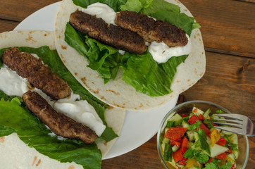 Wrap with pork meal, creame and romaine lettuce