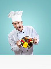 Humorous portrait of a chef with vegetables looking at camera