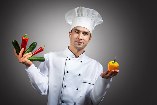 Humorous portrait of a chef with vegetables in his hands