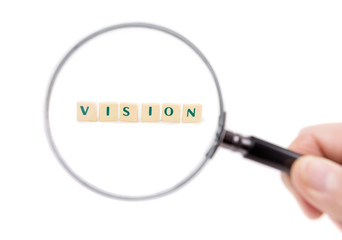 Magnifier enlarges the word vision. On a white background.