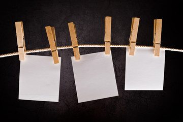 Three Blank paper notes hanging on rope with clothes pins