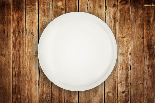 Empty plate on wooden table