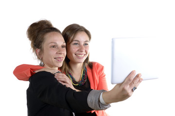 two pretty teen girls taking selfies with her digital tablet