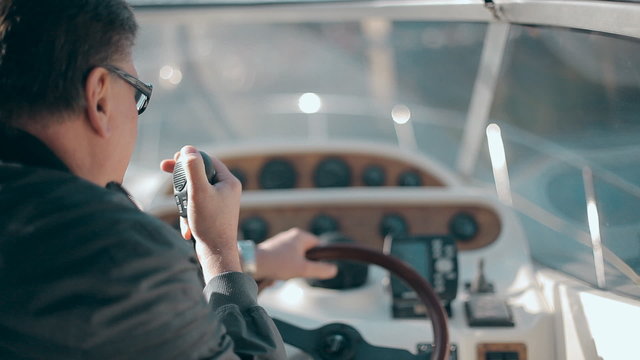 Man with radio set on the yacht