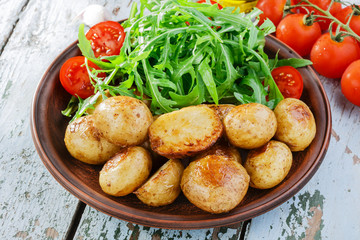 young whole baked potato  arugula
