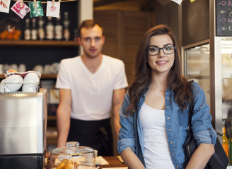 Portrait of smiling waiter and beautiful female customer