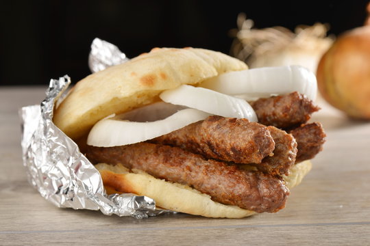 Traditional cevapcici with ajvar in the grilled roll