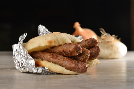Traditional cevapcici with ajvar in the grilled roll