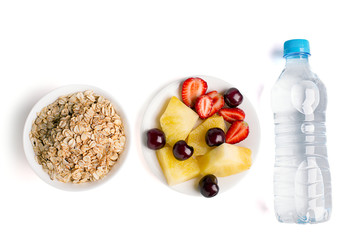 Healthy eating: muesli, berries, pineapple and bottle of water