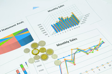 business charts and graph with coins