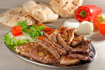 Wholesome platter of mixed meats including grilled steak