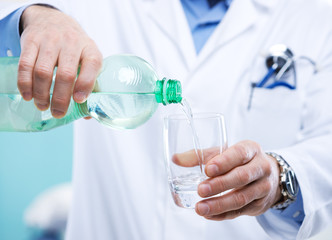 Doctor pouring water