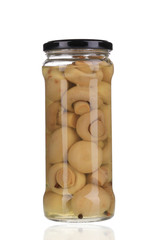 Marinated champignon mushrooms in glass jar.