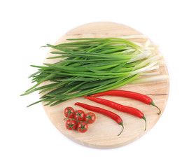 Fresh vegetables on wooden platter.