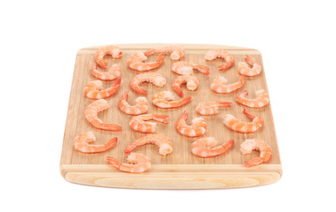 Boiled shrimps on cutting board.