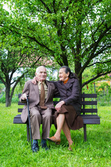 Cute 80 plus year old married couple in their garden.
