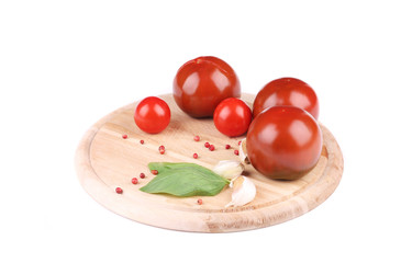 Tomatoes with garlic and basil on platter.