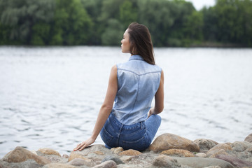 Sad woman sitting on rocks