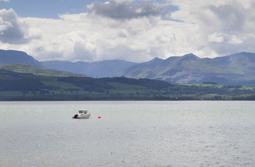 Single boat moored near Beaumaris in Anglesey, North Wales, UK