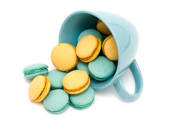Obraz premium orange and blue macarons in a blue cup