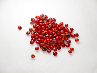 pile of red luck seed on white background