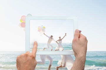 Obraz na płótnie Canvas Composite image of hand holding tablet pc