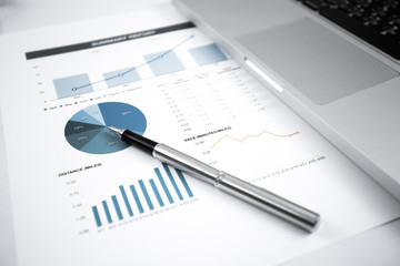 Businessman analyzing investment charts with laptop