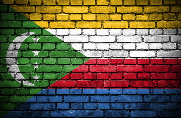 Brick wall with painted flag of Comoros