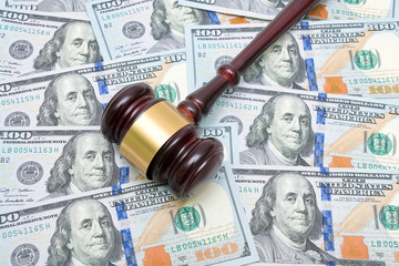 gavel on a background of U.S. dollars