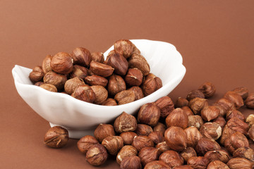 nuts in a bowl on a brown background