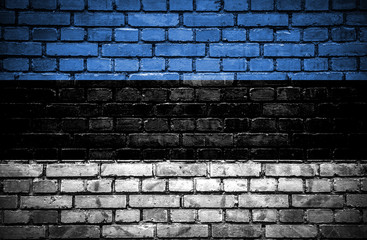 Brick wall with painted flag of Estonia