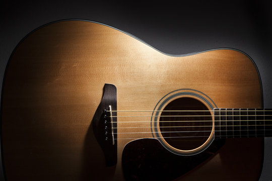 acoustic guitar detail on black background