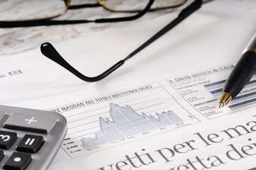 Newspaper, pen and glasses