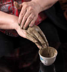 Woman applying spa cosmetic clay cream