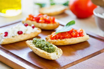 Crostini with Pesto, Cheese,and Tomato