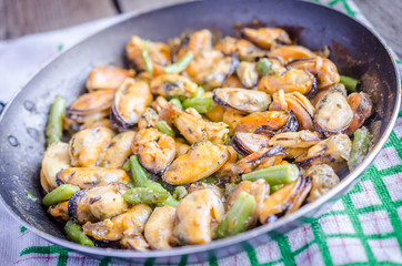 Fried mussels on the pan