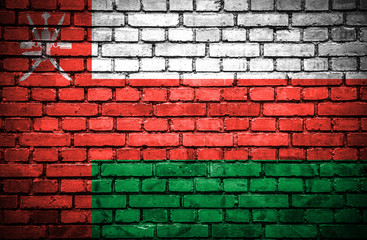 Brick wall with painted flag of Oman