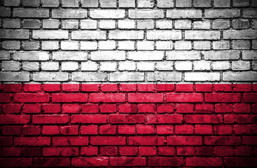 Fototapeta na wymiar Brick wall with painted flag of Poland
