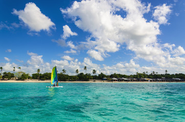Obraz premium Colorful catamaran on azure water against azure water