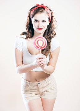 Pin up girl with big lollipop