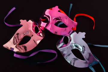Three carnival masks on  dark background