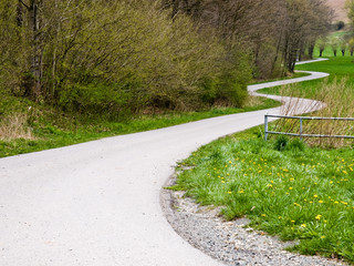 Asphalt road sharp curve along with tropical forest zigzag ahead