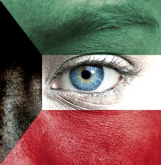 Human face painted with flag of Kuwait