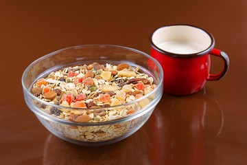 Breakfast cereals, oatmeal in a glass bowl and red cup milk