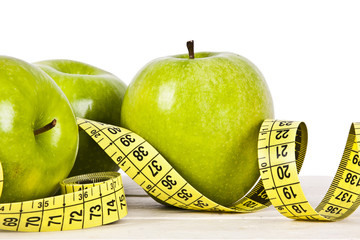 green apples with tape measure, concept of healthy diet